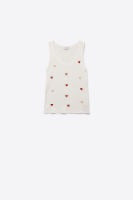 A sleeveless white baby top with small red embroidered hearts, shown against a plain white background.